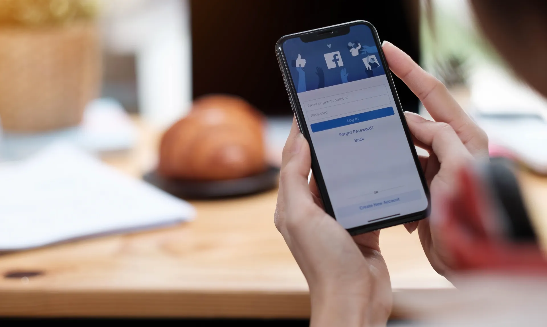 woman-holding-smartphone-with-social-internet-service-facebook-screen